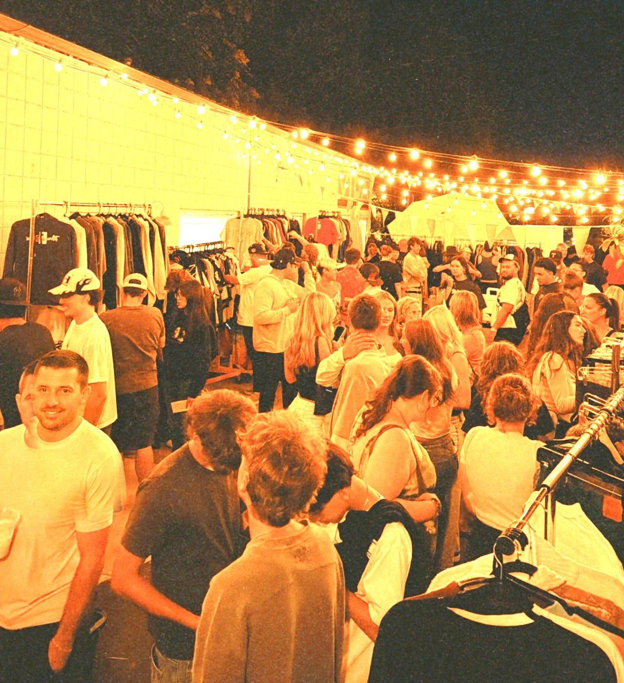 Crowd moving through the racks at an evening FoundF1rst pop-up