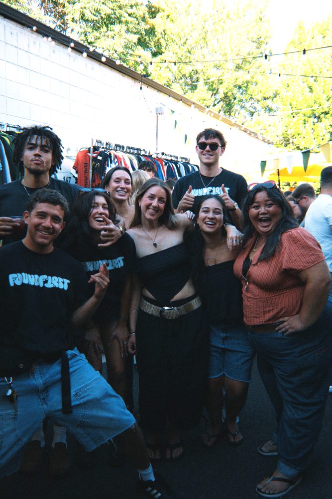 The crew packed together in front of the racks, laughing